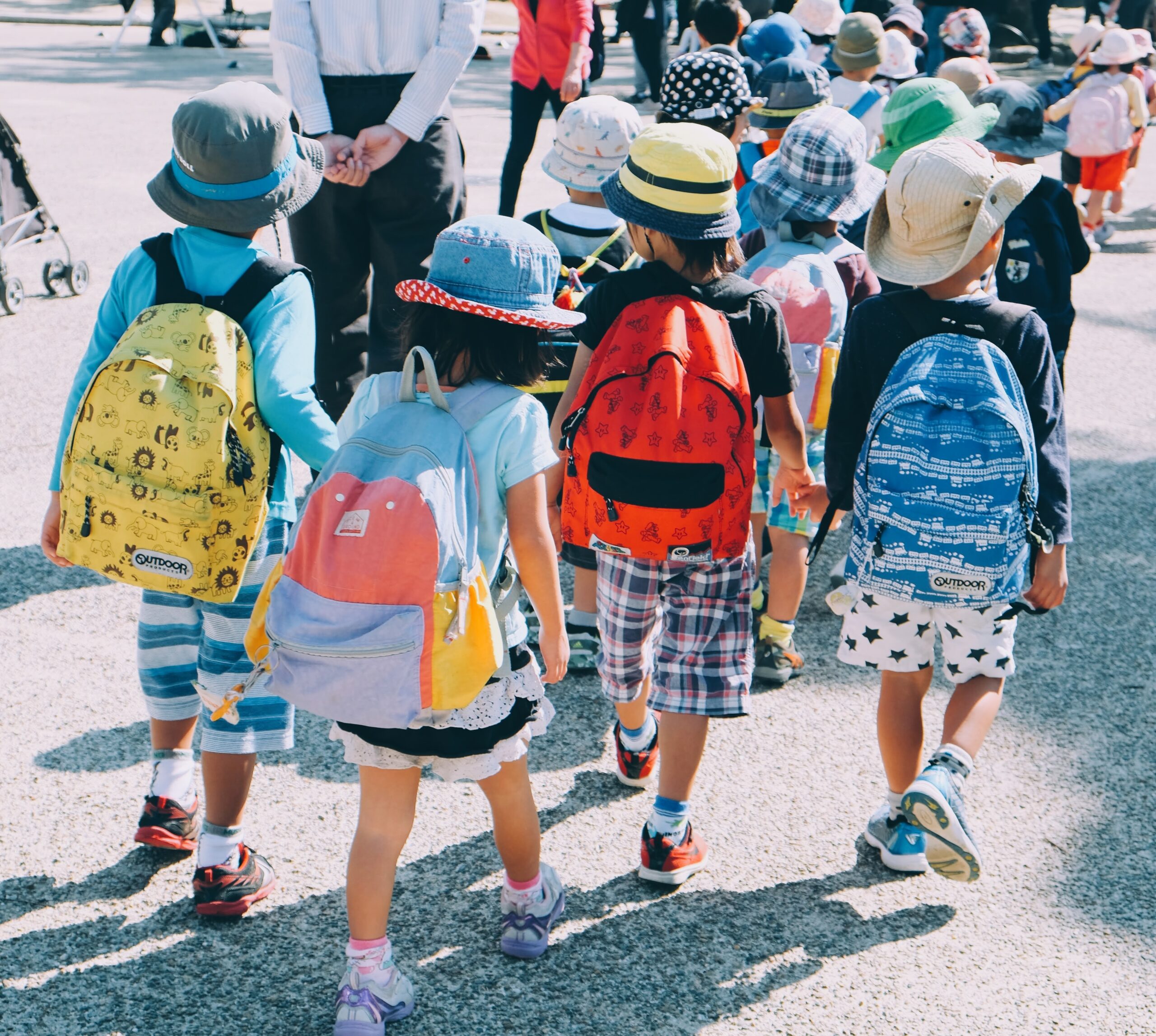 Group of children wearing backpacks and walking together