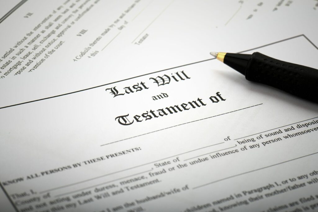 Pen resting on paper saying "Last Will and Testament of"
