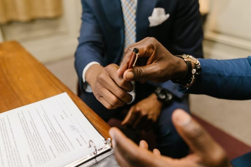 Men in suits signing paper