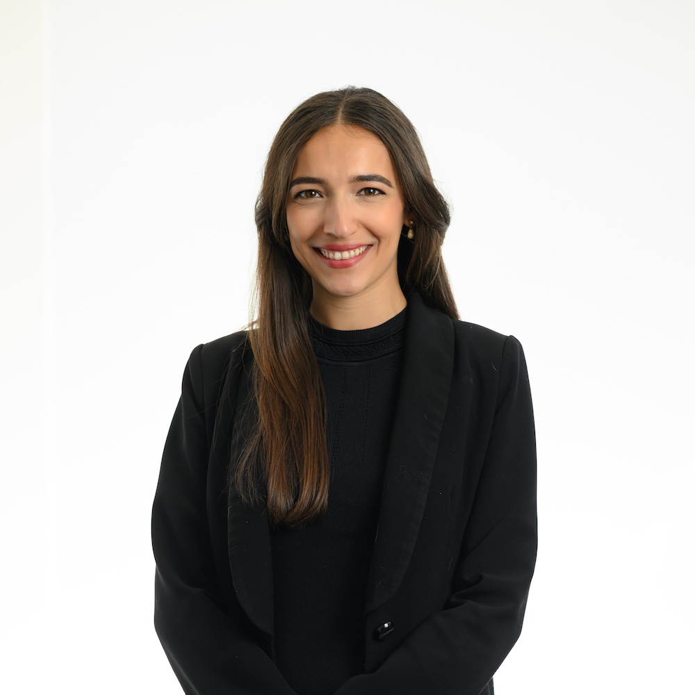 Smiling female lawyer in a black blazer, representing Rafton Family Lawyers, Sydney. Expert in family law and divorce services.