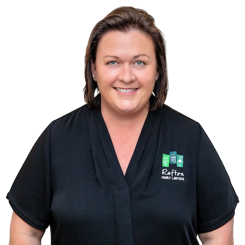 Julia, a compassionate family lawyer at Rafton Family Lawyers, smiling confidently in a professional black attire, representing trust and expertise in family law services in Sydney.