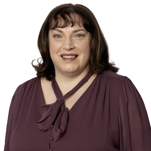 Portrait of Gabriella Fenech, a family and divorce lawyer at Rafton Family Lawyers in Sydney, wearing a purple blouse, smiling warmly.